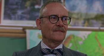 Movie still from “To Die For” (1995), directed by Gus Van Sant – An older man wearing glasses and a bow tie; Close Up shot, Low angle