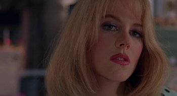 Movie still from “To Die For” (1995), directed by Gus Van Sant – A person with blonde hair; Close Up shot, Over the shoulder angle