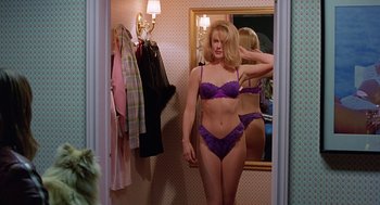 Movie still from “To Die For” (1995), directed by Gus Van Sant – A woman in a purple bra standing in front of a bathroom mirror; Medium shot, Over the shoulder angle