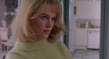 Movie still from “To Die For” (1995), directed by Gus Van Sant – A woman with blonde hair wearing a yellow sweater; Close Up shot, Low angle