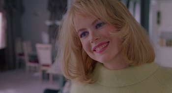 Movie still from “To Die For” (1995), directed by Gus Van Sant – A person with blonde hair; Close Up shot, Over the shoulder angle