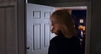 Movie still from “To Die For” (1995), directed by Gus Van Sant – A woman standing in front of an open white door; Close Up shot, Over the shoulder angle