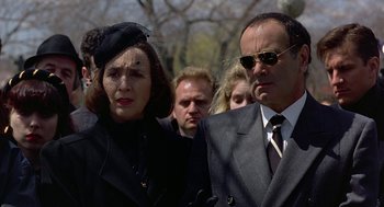 Movie still from “To Die For” (1995), directed by Gus Van Sant – A man and a woman standing next to each other; Medium shot, Low angle