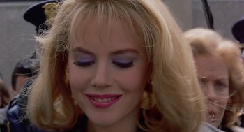 Movie still from “To Die For” (1995), directed by Gus Van Sant – A person wearing a black shirt; Close Up shot, Over the shoulder angle