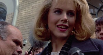 Movie still from “To Die For” (1995), directed by Gus Van Sant – A person wearing a jacket; Close Up shot, Over the shoulder angle