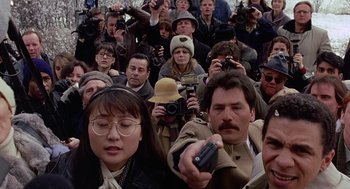 Movie still from “To Die For” (1995), directed by Gus Van Sant – A large group of people gathered in the street; Close Up shot, High angle