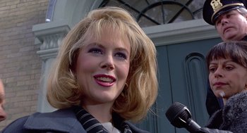 Movie still from “To Die For” (1995), directed by Gus Van Sant – A person holding a microphone; Close Up shot, Low angle