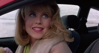 Movie still from “To Die For” (1995), directed by Gus Van Sant – A woman in a car wearing a black hat; Close Up shot, Over the shoulder angle