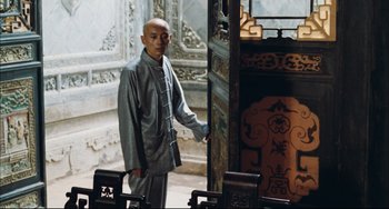 Movie still from “To Live” (1994), directed by Yimou Zhang – A man standing in front of an open door; Medium shot, Over the shoulder angle