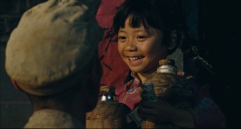 Movie still from “To Live” (1994), directed by Yimou Zhang – A little girl smiling and holding two bottles; Close Up shot, Over the shoulder angle