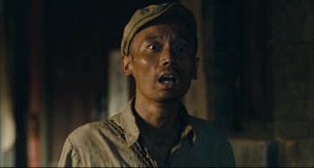 Movie still from “To Live” (1994), directed by Yimou Zhang – A person wearing a hat; Close Up shot, Low angle