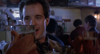 Movie still from “To Live and Die in L.A.” (1985), directed by William Friedkin – A person holding a glass of beer; Close Up shot, Low angle