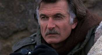 Movie still from “To Live and Die in L.A.” (1985), directed by William Friedkin – An older man with a mustache wearing a jacket; Close Up shot, High angle