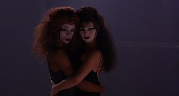 Movie still from “To Live and Die in L.A.” (1985), directed by William Friedkin – A couple of women standing next to each other; Close Up shot, Low angle