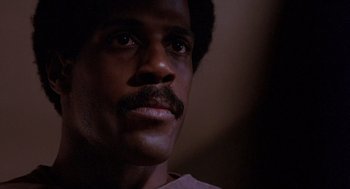 Movie still from “To Live and Die in L.A.” (1985), directed by William Friedkin – A person with a mustache; Close Up shot, Low angle