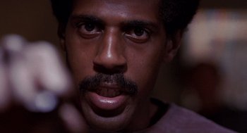 Movie still from “To Live and Die in L.A.” (1985), directed by William Friedkin – A person with a mustache; Close Up shot, Low angle
