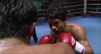 Movie still from “Tokyo Fist” (1995), directed by Shin'ya Tsukamoto – Two young men in a boxing ring with red mitts; Close Up shot, Over the shoulder angle
