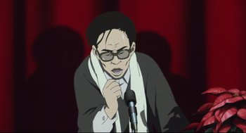Movie still from “Tokyo Godfathers” (2003), directed by Shôgo Furuya – An animated man with glasses is holding a microphone; Close Up shot, Low angle