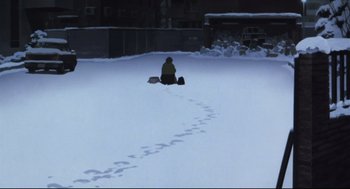 Movie still from “Tokyo Godfathers” (2003), directed by Shôgo Furuya – A person kneeling down in the snow near a building; Wide shot, High angle