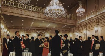 Movie still from “Tokyo Godfathers” (2003), directed by Shôgo Furuya – A group of people standing in a room with glasses; Extreme Wide shot, Low angle