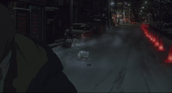 Movie still from “Tokyo Godfathers” (2003), directed by Shôgo Furuya – A city street at night with smoke coming out of the street; Wide shot, High angle