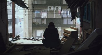 Movie still from “Tokyo Godfathers” (2003), directed by Shôgo Furuya – A person sitting on the floor of a building; Extreme Wide shot, Low angle