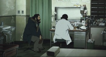 Movie still from “Tokyo Godfathers” (2003), directed by Shôgo Furuya – Two men sitting in front of a computer desk; Wide shot, High angle