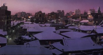 Movie still from “Tokyo Godfathers” (2003), directed by Shôgo Furuya – A view of a city at night with snow on the rooftops; Extreme Wide shot, High angle