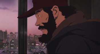 Movie still from “Tokyo Godfathers” (2003), directed by Shôgo Furuya – A man with a beard and a hat looking out of a window; Close Up shot, Low angle