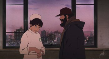 Movie still from “Tokyo Godfathers” (2003), directed by Shôgo Furuya – A man and a woman standing next to each other in front of a window; Medium shot, Over the shoulder angle