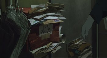 Movie still from “Tokyo Godfathers” (2003), directed by Shôgo Furuya – A pile of mail sitting on top of a wooden box; Medium shot, Low angle