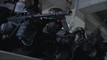 Movie still from “Tokyo Gore Police” (2008), directed by Yoshihiro Nishimura – A group of people with guns and helmets; Close Up shot, Low angle