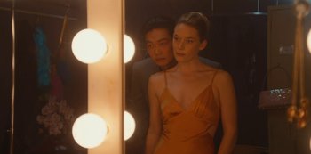 Movie still from “Tokyo Vice” (2022), created by J.T. Rogers – A man and a woman standing in front of a mirror; Medium shot, Over the shoulder angle