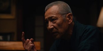 Movie still from “Tokyo Vice” (2022), created by J.T. Rogers – An older man is looking at the camera; Close Up shot, Low angle