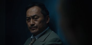 Movie still from “Tokyo Vice” (2022), created by J.T. Rogers – A person wearing a suit and tie; Close Up shot, Low angle