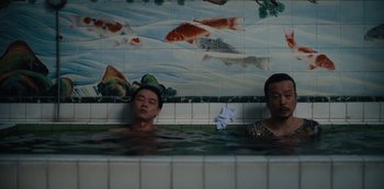 Movie still from “Tokyo Vice” (2022), created by J.T. Rogers – Two men are in a pool of water; Medium shot, High angle
