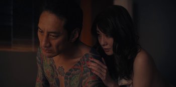 Movie still from “Tokyo Vice” (2022), created by J.T. Rogers – A man and a woman are looking at each other; Close Up shot, High angle