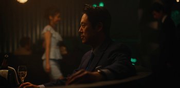 Movie still from “Tokyo Vice” (2022), created by J.T. Rogers – A man in a suit and a woman in a white dress; Medium shot, Over the shoulder angle