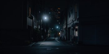 Movie still from “Tokyo Vice” (2022), created by J.T. Rogers – Two people are walking down the street at night; Extreme Wide shot, Low angle