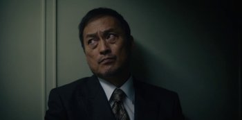 Movie still from “Tokyo Vice” (2022), created by J.T. Rogers – A person wearing a suit and tie; Close Up shot, Low angle