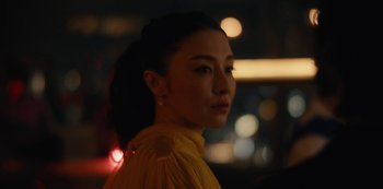 Movie still from “Tokyo Vice” (2022), created by J.T. Rogers – A person wearing a yellow dress; Close Up shot, Over the shoulder angle