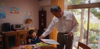 Movie still from “Tokyo Vice” (2022), created by J.T. Rogers – An older man and a young girl at a dining table; Medium shot, Over the shoulder angle