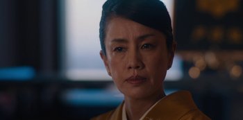 Movie still from “Tokyo Vice” (2022), created by J.T. Rogers – A person wearing a yellow jacket; Close Up shot, Low angle