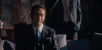 Movie still from “Tokyo Vice” (2022), created by J.T. Rogers – A person wearing a suit and a tie; Medium shot, Low angle