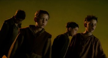 Movie still from “Tom Thumb” (2001), directed by Olivier Dahan – A group of young men standing next to each other; Medium shot, Low angle