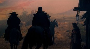 Movie still from “Tom Thumb” (2001), directed by Olivier Dahan – A group of people riding horses in a field; Wide shot, Low angle