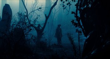 Movie still from “Tom Thumb” (2001), directed by Olivier Dahan – Two people are standing in the woods in the fog; Wide shot, Low angle