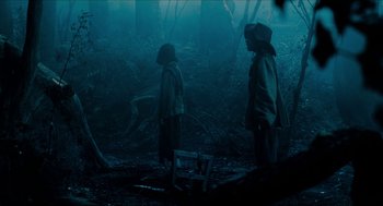 Movie still from “Tom Thumb” (2001), directed by Olivier Dahan – Two people standing in the middle of a forest; Wide shot, Low angle