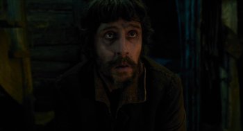 Movie still from “Tom Thumb” (2001), directed by Olivier Dahan – A person with a beard; Close Up shot, Low angle