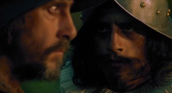 Movie still from “Tom Thumb” (2001), directed by Olivier Dahan – A man with long hair and a beard looking at a man with long hair and a beard; Close Up shot, Over the shoulder angle